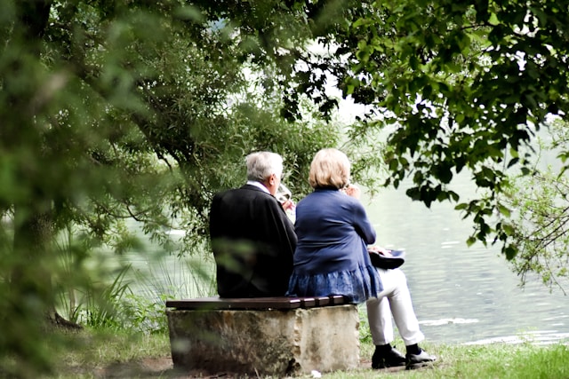 Couple sitting by a lake 